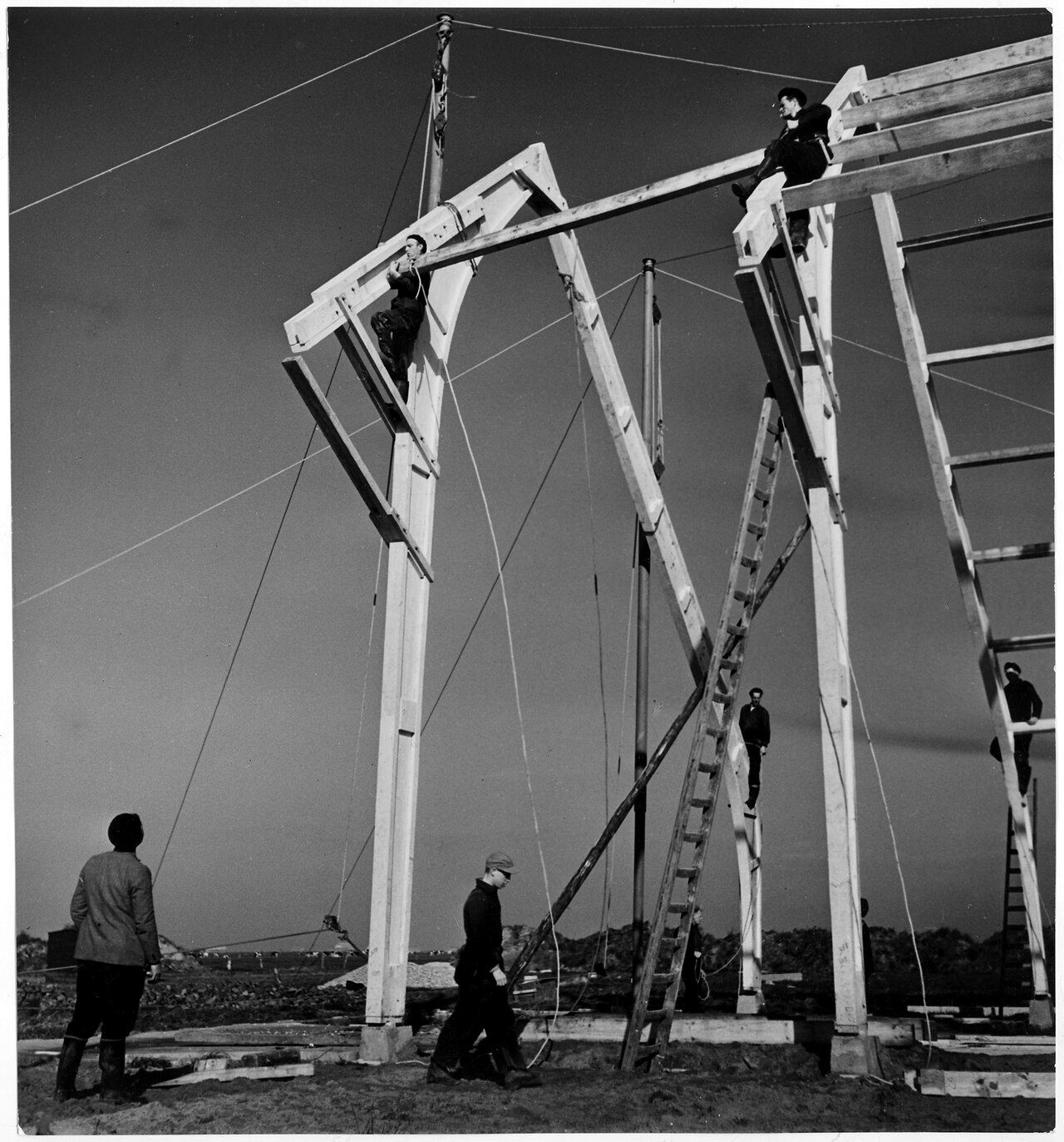 Black and white photograph of a crew framing a building, around 1950
